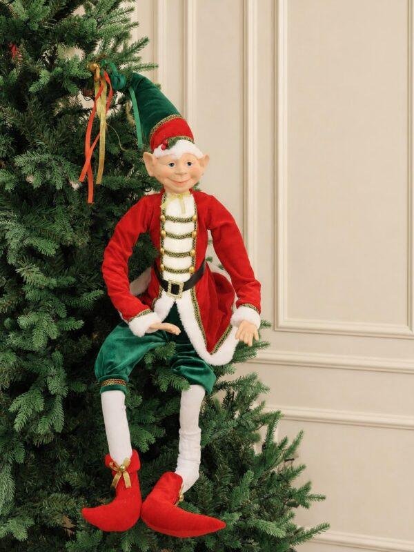 Bring festive charm to your holiday décor with this Christmas Elf. Designed with flexible arms and legs, it can be bent and posed in different ways to decorate Christmas trees, wreaths, garlands, shelves, mantels, stair railings, and holiday displays. Made with soft fabric and detailed festive clothing, it’s perfect for homes, shops, offices, and seasonal decorations. Explore more Christmas elves, ornaments, trees, wreaths, garlands, and holiday décor at Rojeh Store – Jordan.