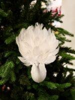 Bring graceful elegance to your Christmas décor with this handcrafted white feather bird ornament. Featuring soft layered feathers and a long flowing tail, it adds movement, texture, and a luxurious touch to your Christmas tree, wreaths, garlands, or festive centerpieces. Its lightweight clip design makes decorating easy while creating a timeless winter look. Features * Handcrafted decorative feather bird * Soft white layered feathers with a long elegant tail * Easy clip attachment for secure placement * Perfect for Christmas trees, wreaths, garlands, and centerpieces * Designed to complement both classic and modern holiday décor